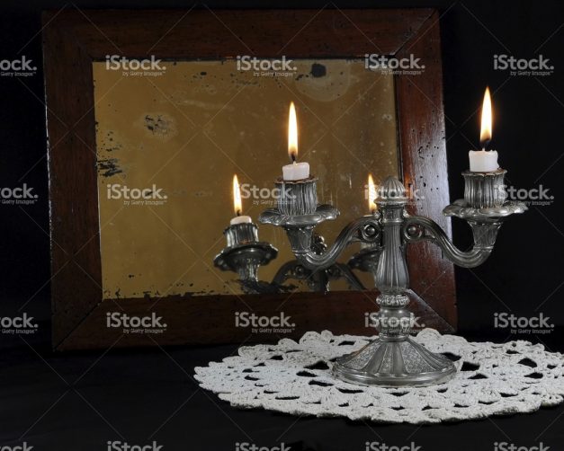 stock-photo-92478603-old-silver-candlestick-reflected-in-the-mirror-damaged